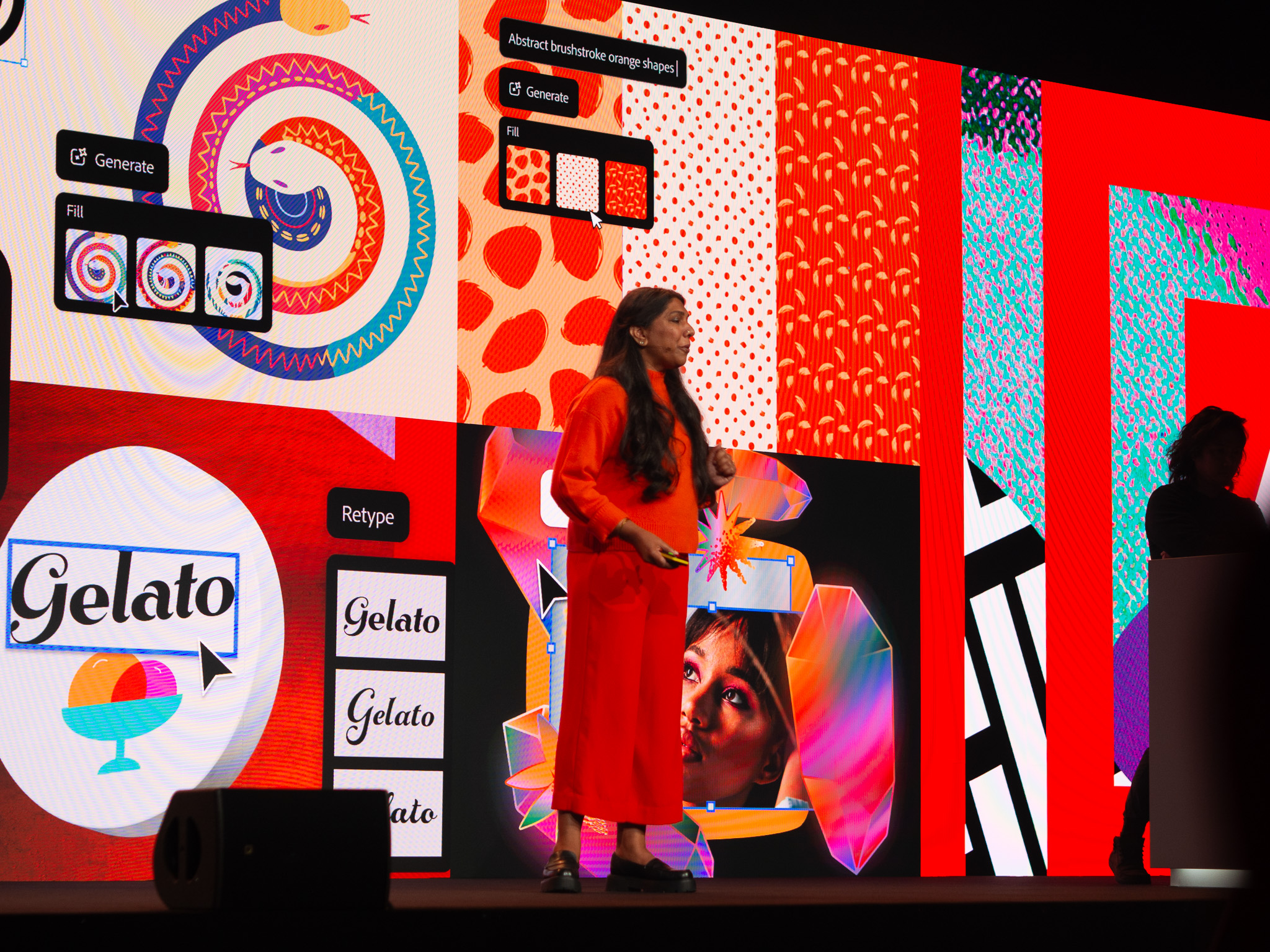 Deepa Subramaniam steht auf der Bühne der Adobe MAX vor einer bunten collage aus Interfaces